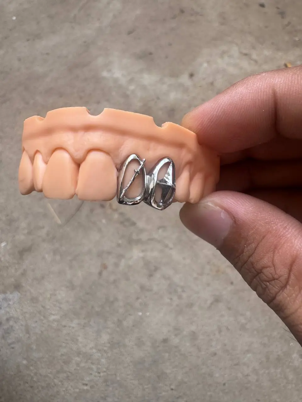 Close up of Custom star x sword grillz dental jewelry